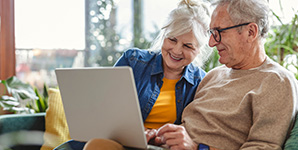 Older couple reviewing their retirement plan on computer.