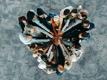 A group of people putting their hands in.